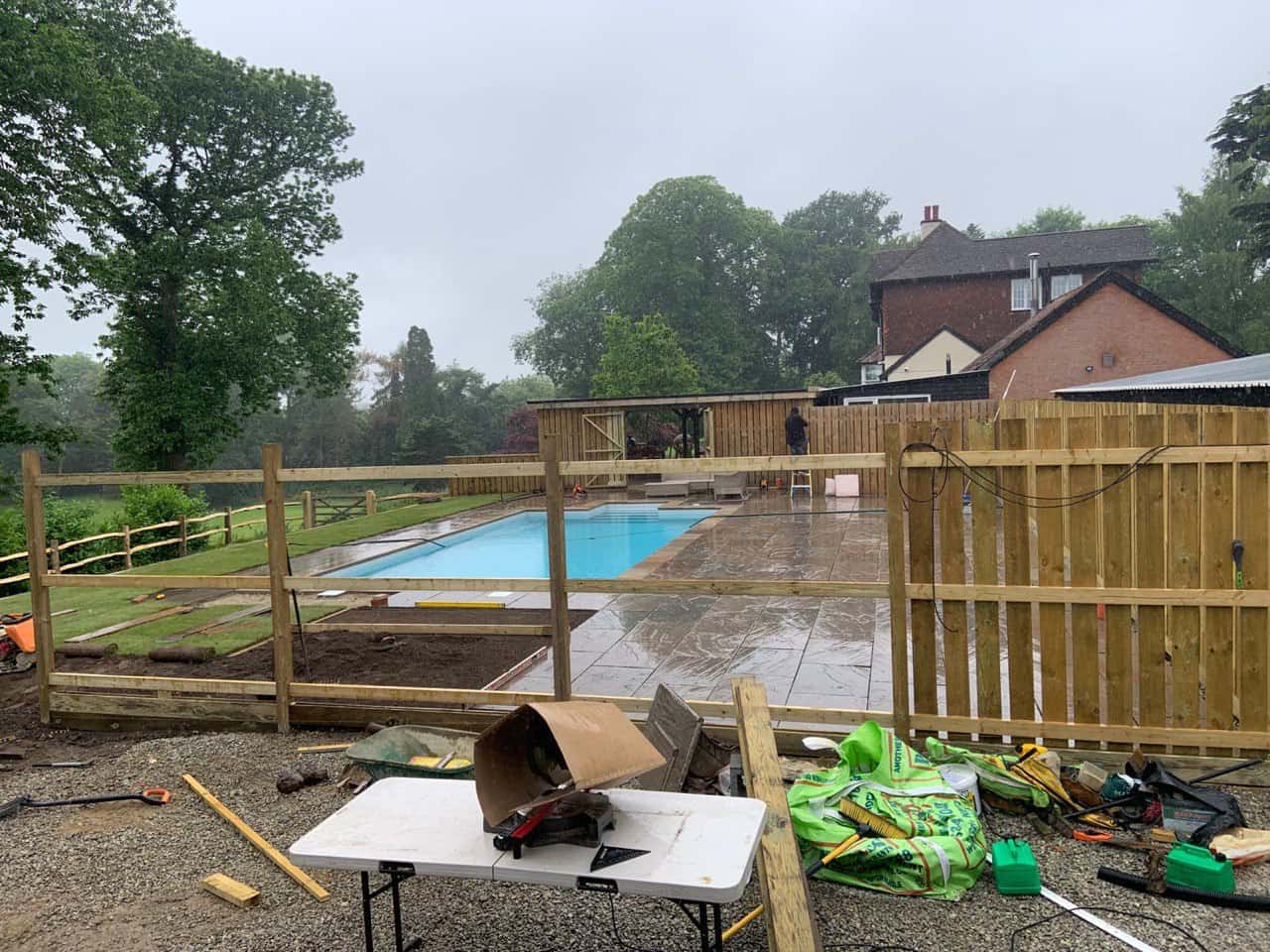 This is a photo of Bespoke custom fencing installed around a swimming pool by Fast Fix Fencing Godstone