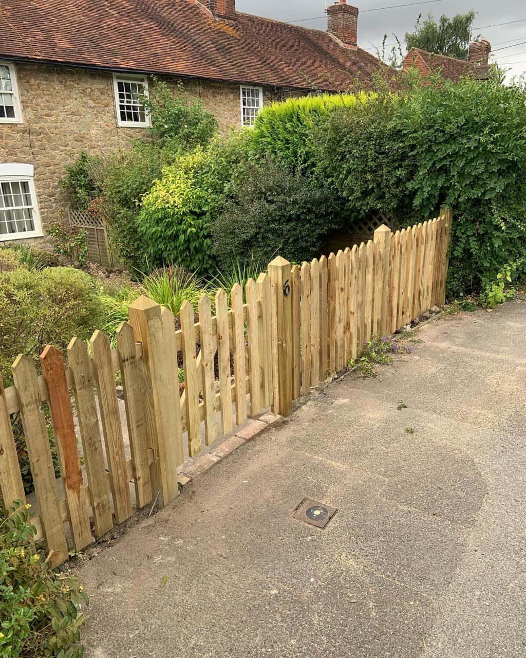 This is a photo of a picket fence and picket gate installed by Fast Fix Fencing Godstone